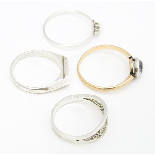 622 - 4 assorted white metal and yellow metal rings (4)