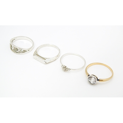 622 - 4 assorted white metal and yellow metal rings (4)