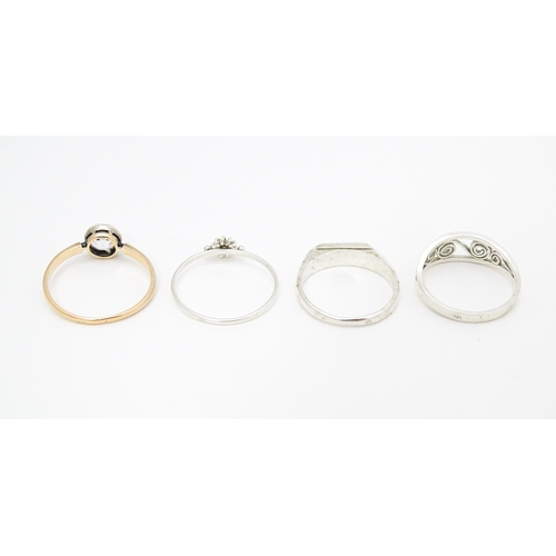 622 - 4 assorted white metal and yellow metal rings (4)