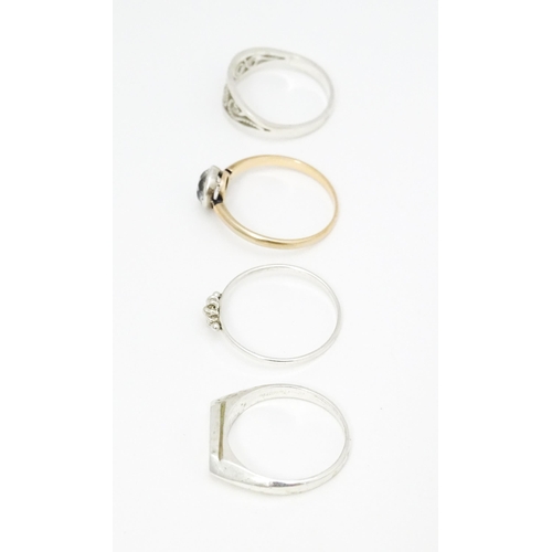 622 - 4 assorted white metal and yellow metal rings (4)