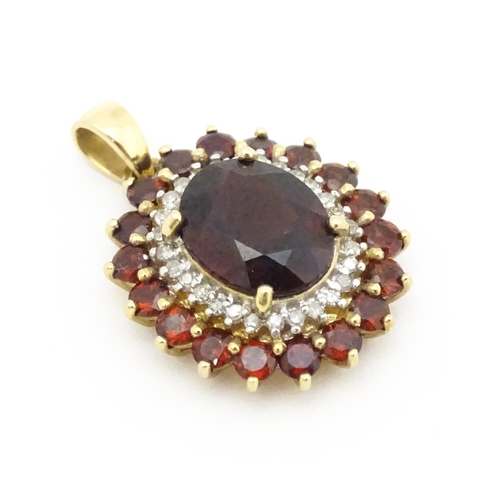 626 - A 9ct gold pendant set with garnets and diamonds. Approx. 3/4