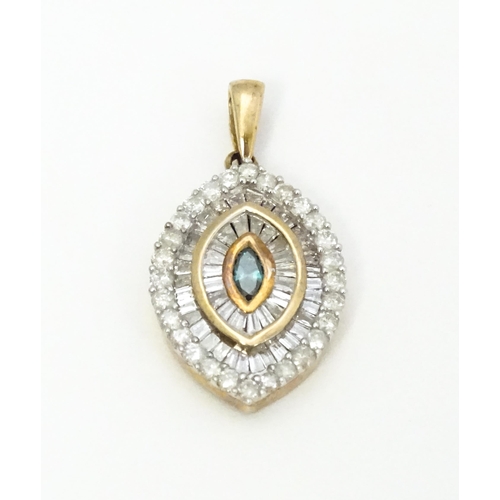 629 - A 9ct gold pendant set with a profusion of diamonds  and central coloured diamond. Approx. 3/4