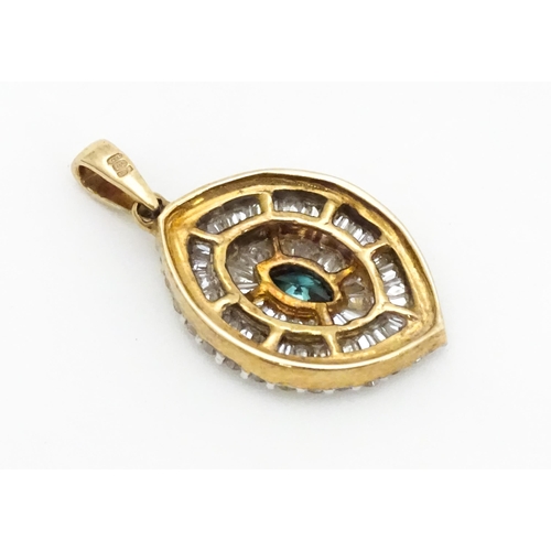 629 - A 9ct gold pendant set with a profusion of diamonds  and central coloured diamond. Approx. 3/4