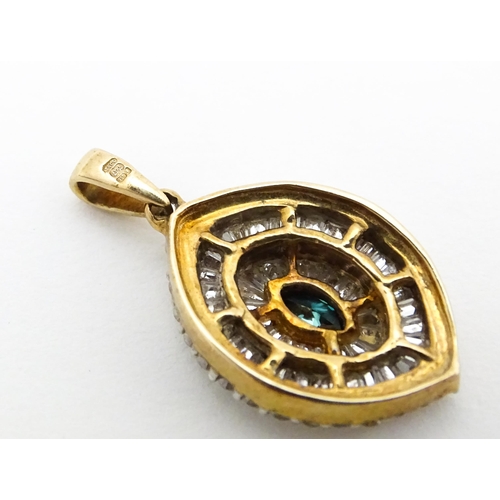 629 - A 9ct gold pendant set with a profusion of diamonds  and central coloured diamond. Approx. 3/4