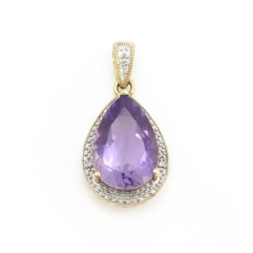 632 - A 9ct gold pendant set with amethyst and diamonds. Approx. 1