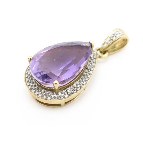 632 - A 9ct gold pendant set with amethyst and diamonds. Approx. 1