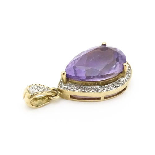 632 - A 9ct gold pendant set with amethyst and diamonds. Approx. 1