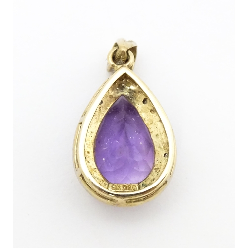 632 - A 9ct gold pendant set with amethyst and diamonds. Approx. 1