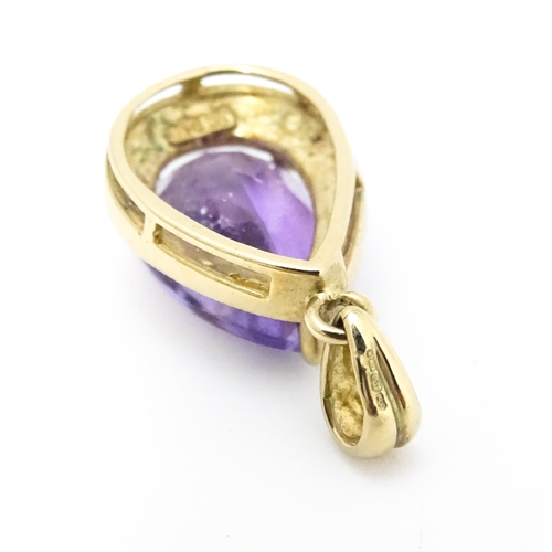 632 - A 9ct gold pendant set with amethyst and diamonds. Approx. 1