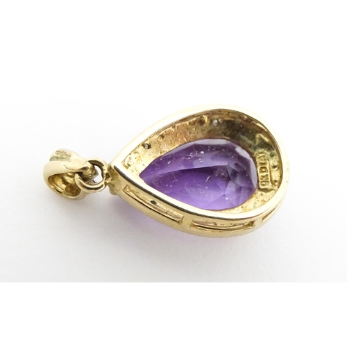 632 - A 9ct gold pendant set with amethyst and diamonds. Approx. 1