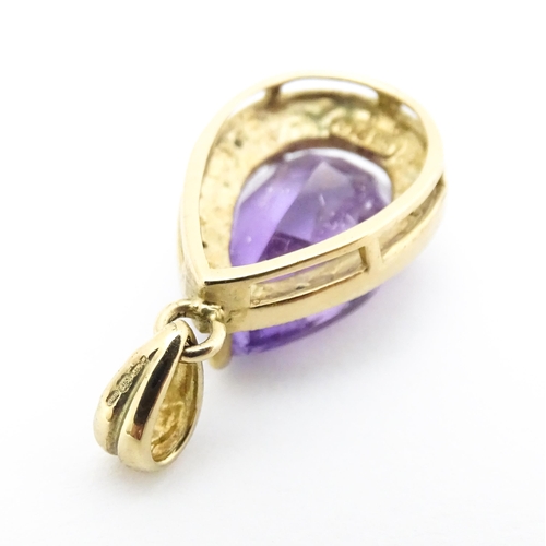 632 - A 9ct gold pendant set with amethyst and diamonds. Approx. 1