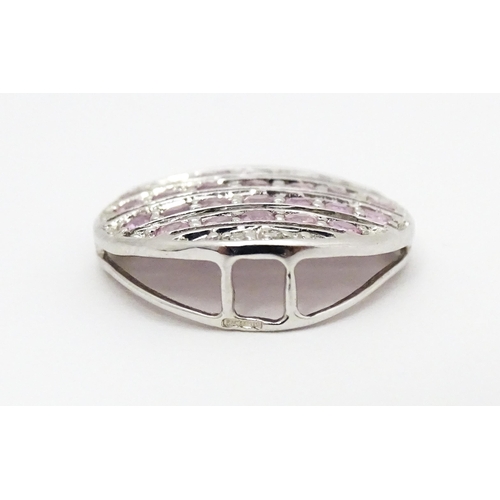 638 - A 9ct white gold pendant of oval form set with diamonds and pink sapphires. Approx. 7/8