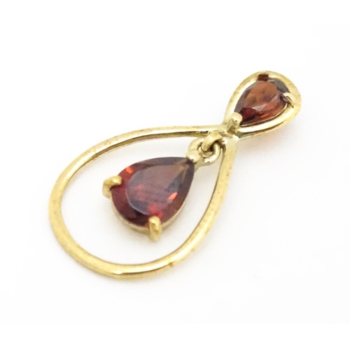 641 - A 9ct gold pendant set with garnets. Approx. 1