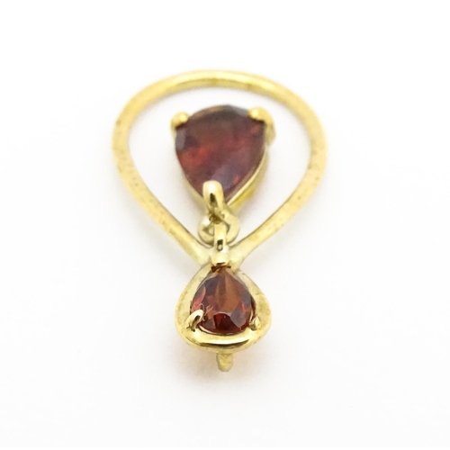 641 - A 9ct gold pendant set with garnets. Approx. 1