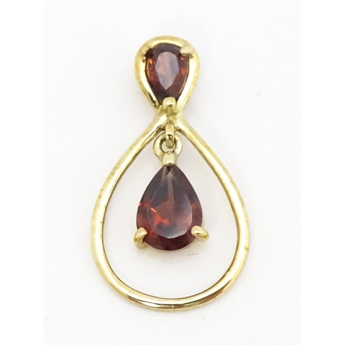 641 - A 9ct gold pendant set with garnets. Approx. 1