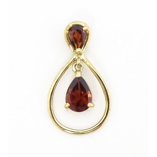 641 - A 9ct gold pendant set with garnets. Approx. 1