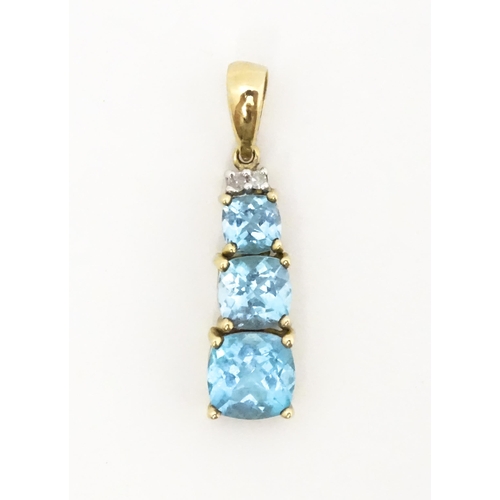 642 - A 9ct gold pendant set with two diamonds and three graduated topaz. Approx. 1