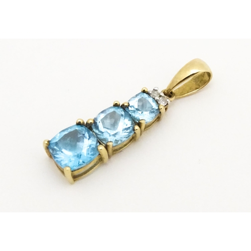 642 - A 9ct gold pendant set with two diamonds and three graduated topaz. Approx. 1