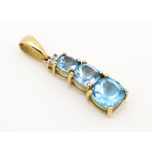 642 - A 9ct gold pendant set with two diamonds and three graduated topaz. Approx. 1