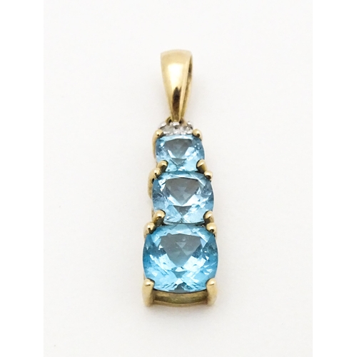 642 - A 9ct gold pendant set with two diamonds and three graduated topaz. Approx. 1