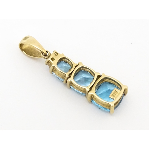 642 - A 9ct gold pendant set with two diamonds and three graduated topaz. Approx. 1