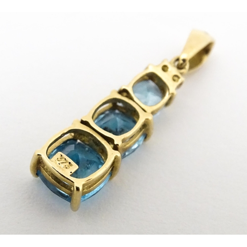 642 - A 9ct gold pendant set with two diamonds and three graduated topaz. Approx. 1