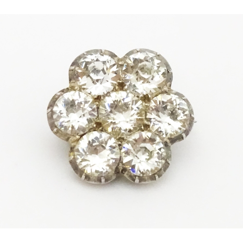 646 - A white metal brooch set with white paste stones in a daisy setting. Approx. 3/4