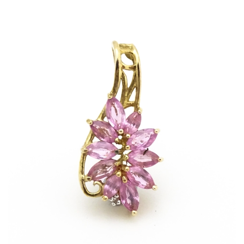 647 - A 9ct gold pendant set with pink sapphires and diamond. Approx. 1