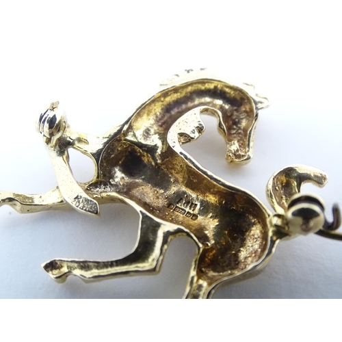 650 - A 9ct gold brooch modelled as a prancing horse / pony. Approx. 1 1/2