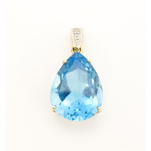 651 - A 9ct gold pendant set with topaz and diamonds. Approx. 1 1/42 long