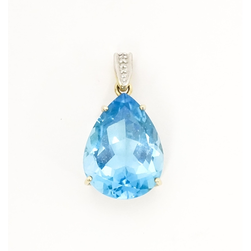 651 - A 9ct gold pendant set with topaz and diamonds. Approx. 1 1/42 long