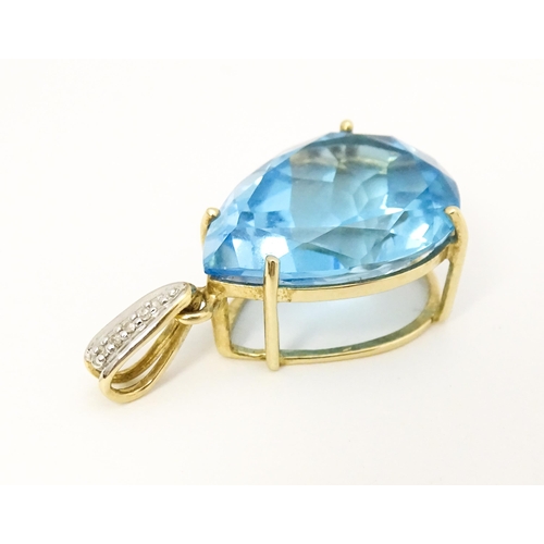 651 - A 9ct gold pendant set with topaz and diamonds. Approx. 1 1/42 long