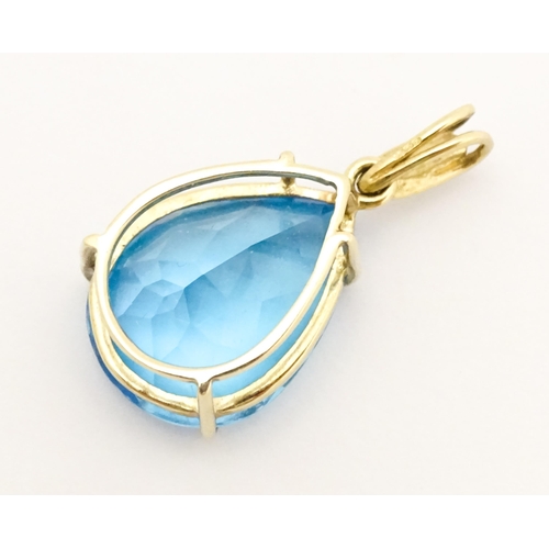 651 - A 9ct gold pendant set with topaz and diamonds. Approx. 1 1/42 long