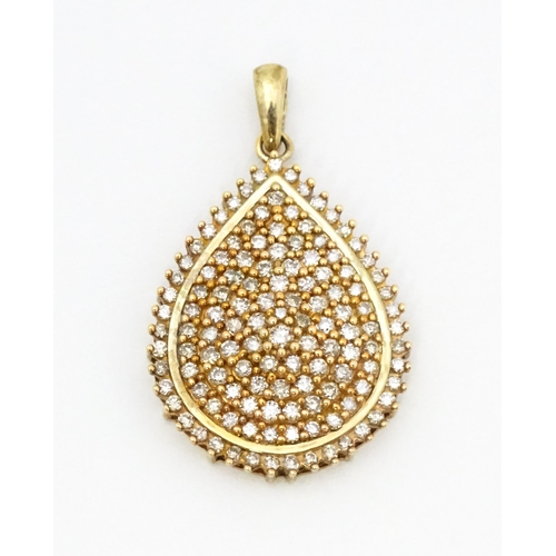 653 - A 9ct gold pendant set with a profusion of diamonds. Approx. 1