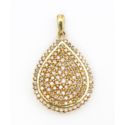 653 - A 9ct gold pendant set with a profusion of diamonds. Approx. 1