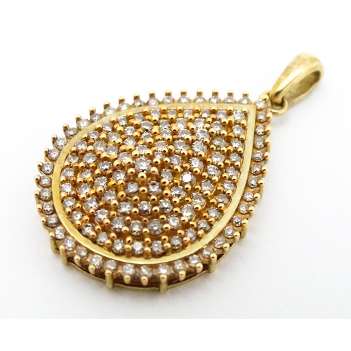 653 - A 9ct gold pendant set with a profusion of diamonds. Approx. 1