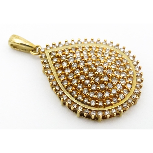 653 - A 9ct gold pendant set with a profusion of diamonds. Approx. 1