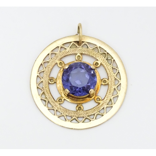 654 - A 14ct gold pendant set with central amethyst. Approx. 1 1/4