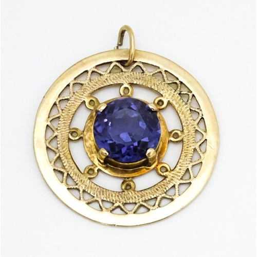 654 - A 14ct gold pendant set with central amethyst. Approx. 1 1/4