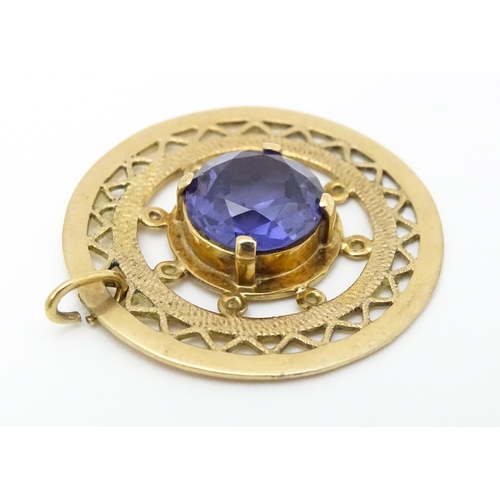 654 - A 14ct gold pendant set with central amethyst. Approx. 1 1/4