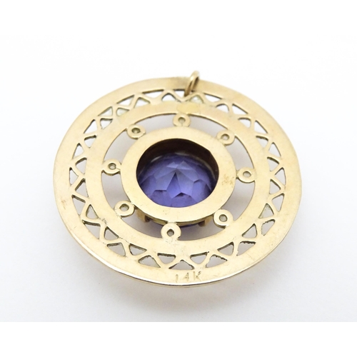 654 - A 14ct gold pendant set with central amethyst. Approx. 1 1/4