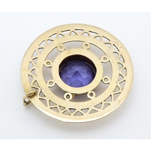 654 - A 14ct gold pendant set with central amethyst. Approx. 1 1/4