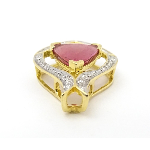 659 - An 18ct gold pendant set with central pink tourmaline bordered by diamonds. Approx. 1