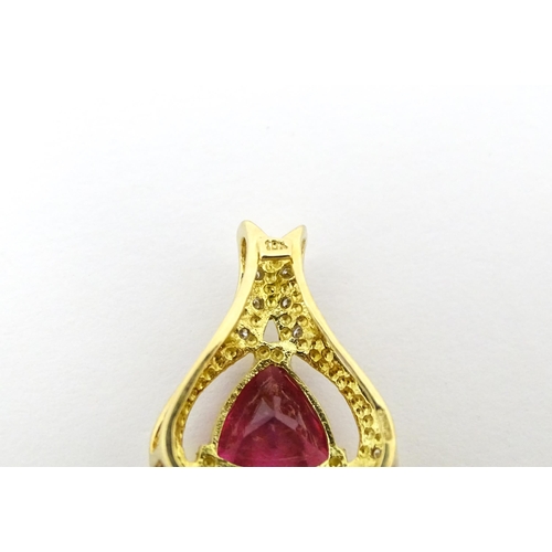 659 - An 18ct gold pendant set with central pink tourmaline bordered by diamonds. Approx. 1