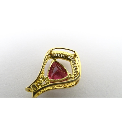 659 - An 18ct gold pendant set with central pink tourmaline bordered by diamonds. Approx. 1