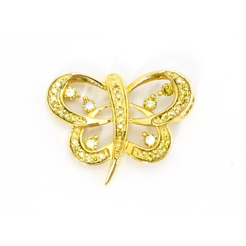 663 - A 9ct gold pendant of stylised butterfly form set with yellow diamonds. Approx. 1