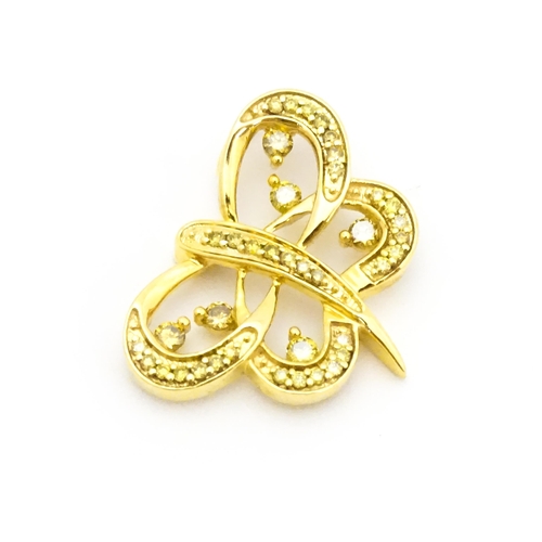 663 - A 9ct gold pendant of stylised butterfly form set with yellow diamonds. Approx. 1