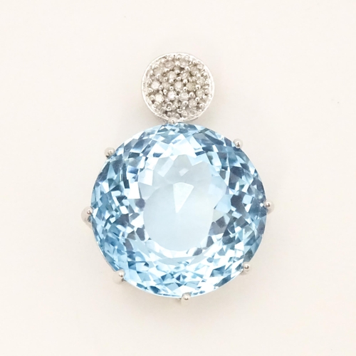 665 - A 9ct white gold pendant set with topaz and diamonds. Approx. 1 1/4