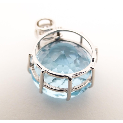 665 - A 9ct white gold pendant set with topaz and diamonds. Approx. 1 1/4