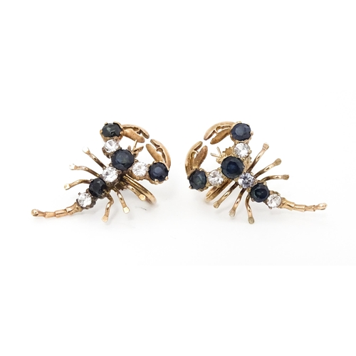 667 - A pair of vintage yellow metal earrings formed as lobsters set with blue and white stones. Approx. 1... 